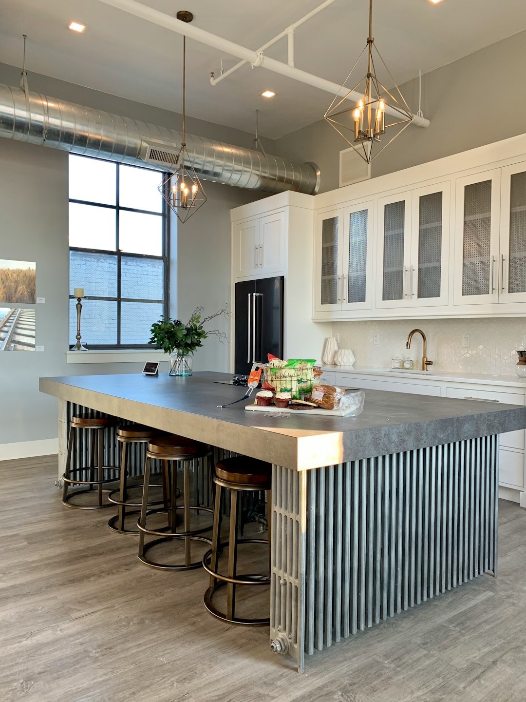 Modern kitchen island with snacks and bar stools.